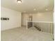 A carpeted upstairs hallway features a black iron railing and white trim at 5937 N Orleans St, Aurora, CO 80019