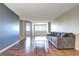 Spacious living room with hardwood floors, large windows, and a gray couch at 2225 Buchtel Blvd # 1109, Denver, CO 80210