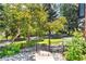 A beautiful backyard featuring mature trees, a trampoline, and gated access at 3253 S King Way, Denver, CO 80236