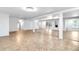 Large finished basement with wood flooring, multiple access doors, and staircase at 3253 S King Way, Denver, CO 80236