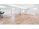 Spacious finished basement features a bar, stairs, and light wood-look flooring throughout at 3253 S King Way, Denver, CO 80236