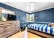 Cozy bedroom with light hardwood flooring and large window at 3253 S King Way, Denver, CO 80236