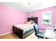 A cozy bedroom featuring pink walls, light colored floors, and a twin sized bed at 3253 S King Way, Denver, CO 80236