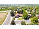 Aerial view showcases a well-maintained single-Gathering home with lush greenery and mature trees at 3253 S King Way, Denver, CO 80236