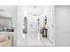 Bright foyer with elegant chandelier, white tile flooring, and an arched entryway at 3253 S King Way, Denver, CO 80236