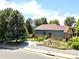 A lovely home with mature landscaping including a terraced front yard and a walkway at 3253 S King Way, Denver, CO 80236