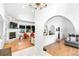 Open-concept living room with fireplace, hardwood floors, and lots of natural light at 3253 S King Way, Denver, CO 80236
