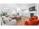 Bright, open living room with fireplace, hardwood floors, and neutral decor at 3253 S King Way, Denver, CO 80236