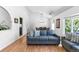 Comfortable living room featuring a large sofa, wood floors, and a dining area at 3253 S King Way, Denver, CO 80236