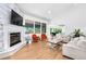 Bright living room with stone fireplace, hardwood floors, and neutral decor at 3253 S King Way, Denver, CO 80236