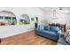 Living room with a sofa, dining area, and modern lighting fixtures at 3253 S King Way, Denver, CO 80236