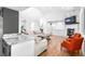 Bright living room with hardwood floors, white stone fireplace, and elegant furnishings at 3253 S King Way, Denver, CO 80236