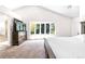 An expansive main bedroom featuring a large window, en suite bathroom, and king size bed at 3253 S King Way, Denver, CO 80236