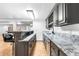 The wet bar boasts elegant marble countertops and gray cabinets with wine storage at 3253 S King Way, Denver, CO 80236