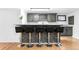 Contemporary wet bar features a marble countertop and is complimented by gray cabinets at 3253 S King Way, Denver, CO 80236