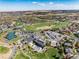 An aerial view showcasing community amenities including a pool, tennis courts, and a clubhouse with parking at 8198 S Sicily Ct, Aurora, CO 80016