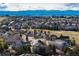 Expansive aerial view of a neighborhood featuring well-maintained lawns, mature trees, and mountain views at 8198 S Sicily Ct, Aurora, CO 80016