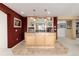 Well-lit basement bar featuring custom cabinetry and countertops with tile flooring, ready for entertaining at 8198 S Sicily Ct, Aurora, CO 80016