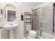 Modern bathroom featuring a pedestal sink, glass-enclosed shower, and neutral finishes at 8198 S Sicily Ct, Aurora, CO 80016