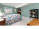 Cozy bedroom features a serene atmosphere with soft green walls and a large window, ideal for relaxation at 8198 S Sicily Ct, Aurora, CO 80016
