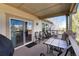 Relaxing covered deck area with a table, chairs, and additional seating for entertaining guests at 8198 S Sicily Ct, Aurora, CO 80016
