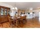 Dining area with wooden table and chairs adjacent to the kitchen area with cabinets at 8198 S Sicily Ct, Aurora, CO 80016