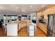 Open kitchen with stainless appliances, granite countertops, and hardwood flooring at 8198 S Sicily Ct, Aurora, CO 80016