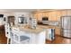 Kitchen with granite countertops, stainless steel appliances, and breakfast bar seating at 8198 S Sicily Ct, Aurora, CO 80016