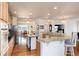 Bright, open kitchen with island seating, granite countertops and modern stainless appliances at 8198 S Sicily Ct, Aurora, CO 80016