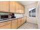 The laundry room has beautiful cabinetry, lots of counter space, and updated vinyl flooring at 8198 S Sicily Ct, Aurora, CO 80016