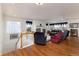 Spacious living room showcasing hardwood floors, a fireplace, and an abundance of natural light at 8198 S Sicily Ct, Aurora, CO 80016