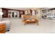 Spacious living room with plush carpet, seating, built-in bookshelves and bar for entertaining at 8198 S Sicily Ct, Aurora, CO 80016