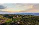 Scenic aerial shot of a residential area boasting lush greenery, rolling hills, and mountain vistas at 7071 Turweston Ln, Castle Pines, CO 80108