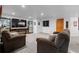 Finished basement with plush carpeting, a large TV, display cases, and comfortable seating at 7071 Turweston Ln, Castle Pines, CO 80108