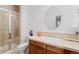 Bathroom with vanity, oval mirror, tiled countertop, and glass-enclosed shower at 7071 Turweston Ln, Castle Pines, CO 80108