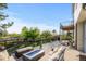 Expansive deck with a fire pit, dining area, and views of the lush backyard at 7071 Turweston Ln, Castle Pines, CO 80108