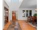 Bright foyer with hardwood floors, high ceilings, and a view of the formal dining area at 7071 Turweston Ln, Castle Pines, CO 80108