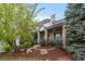 Charming front porch with stone pillars, wood railing, and decorative landscaping creates an inviting entrance at 7071 Turweston Ln, Castle Pines, CO 80108