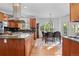 Open kitchen and breakfast nook area with hardwood floors and stainless steel range hood at 7071 Turweston Ln, Castle Pines, CO 80108