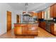 Well-equipped kitchen with stainless appliances, hardwood floors, and granite countertops at 7071 Turweston Ln, Castle Pines, CO 80108