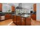 Gourmet kitchen island features a gas cooktop and stainless steel appliances at 7071 Turweston Ln, Castle Pines, CO 80108