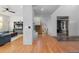 Spacious living room with hardwood floors, a ceiling fan, a staircase, and entryways to other rooms at 7071 Turweston Ln, Castle Pines, CO 80108