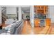 Open living space featuring hardwood floors, views to dining, wet bar, and a fireplace at 7071 Turweston Ln, Castle Pines, CO 80108