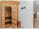 Relaxing sauna with wooden benches, bucket and natural wood, next to an exercise area at 7071 Turweston Ln, Castle Pines, CO 80108