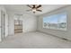 Bright bedroom features plush carpet, an ensuite bathroom, and scenic views at 14902 E Poundstone Dr, Aurora, CO 80015