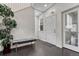 Bright entryway features hardwood floors and a comfortable bench at 14902 E Poundstone Dr, Aurora, CO 80015