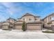 Inviting townhouse exterior featuring stone accents and multiple garages at 14902 E Poundstone Dr, Aurora, CO 80015