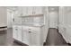 Kitchenette area with gray subway tile backsplash and plenty of cabinet space at 14902 E Poundstone Dr, Aurora, CO 80015