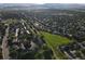 Areal view of a residential neighborhood with lush greenery, tidy streets, and scenic mountain backdrop at 12183 W Chenango Dr, Morrison, CO 80465