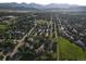 Areal view of a residential neighborhood with lush greenery, tidy streets, and scenic mountain backdrop at 12183 W Chenango Dr, Morrison, CO 80465